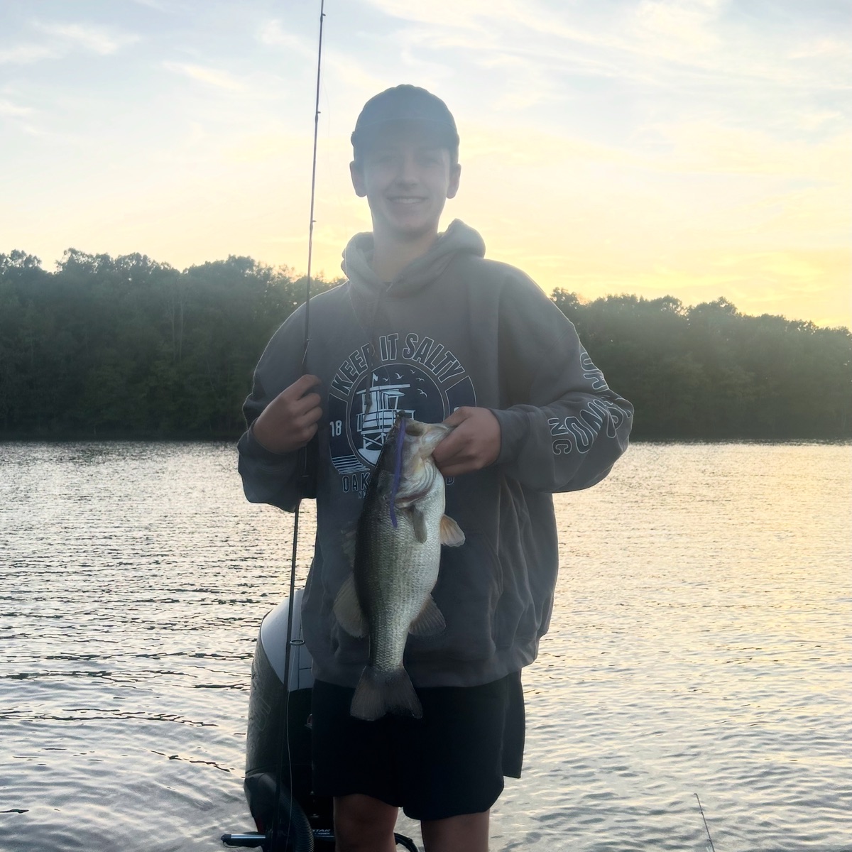 Angler with bass at sunset WiCo lure